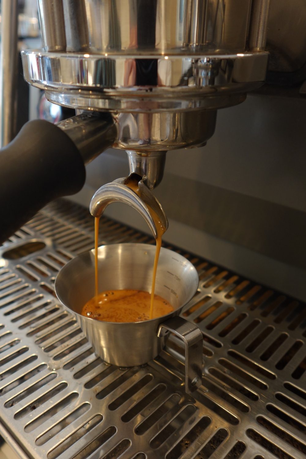 Fresh espresso pouring into a cup at Cube Coffee